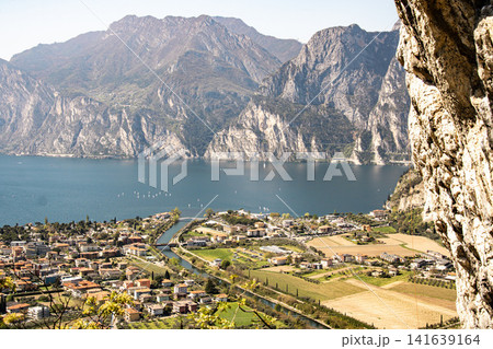 Panoramic View Over Riva Del Garda From Belvedere Climbing Garden: Scenic Landscape In Province Of Trento At Lake Garda Italy Panoramic View Over Riva Del Garda From Belvedere Climbing Garden: Scenic Landscape In Province Of Trento At Lake Garda Italy 141639164