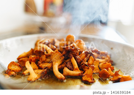Fried chanterelle mushrooms in a frying pan Fried chanterelle mushrooms in a frying pan 141639184
