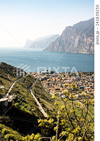 Panoramic View Over Riva Del Garda From Belvedere Climbing Garden: Scenic Landscape In Province Of Trento At Lake Garda Italy Panoramic View Over Riva Del Garda From Belvedere Climbing Garden: Scenic Landscape In Province Of Trento At Lake Garda Italy 141639250
