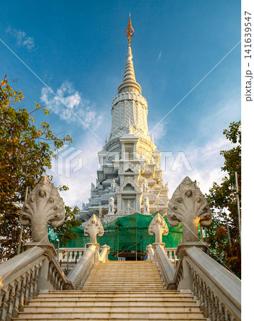 Ancient Stone Face Tower In Udong Cambodia: Historic Temple Monument Rising Above Lush Greenery At Golden Hour 141639547