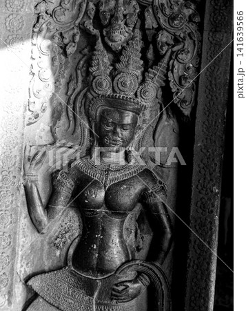 Black and white Stone Relief Of Apsara Dancer In Siem Reap Cambodia: Ancient Khmer Temple Carving Illuminated By Dramatic Side Light Black and white Stone Relief Of Apsara Dancer In Siem Reap Cambodia: Ancient Khmer Temple Carving Illuminated By Dramatic Side Light 141639566