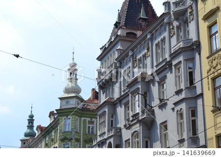 Historic Prague ornate building facades with pastel colors decorative details and tram wires for urban architecture background Historic Prague ornate building facades with pastel colors decorative details and tram wires for urban architecture background 141639669