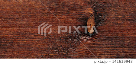 Dark reddish brown wood texture background with natural knot and horizontal grain pattern 141639948