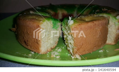 Close up shot of the texture of homemade sponge cake filling on a green tray. Close up shot of the texture of homemade sponge cake filling on a green tray. 141640594