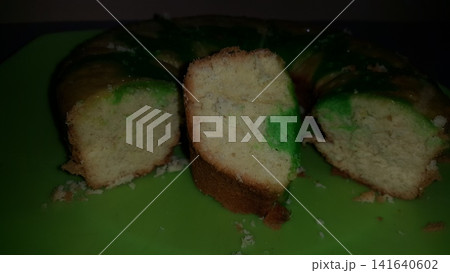 Close up shot of the texture of homemade sponge cake filling on a green tray. 141640602