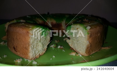 Close up shot of the texture of homemade sponge cake filling on a green tray. Close up shot of the texture of homemade sponge cake filling on a green tray. 141640604