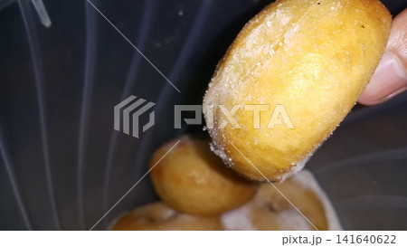 Selective focus shot of delicious and indulgent sweet sugar donut. Donut, Donut or Doughnut, popular cake made from flour and potatoes with icing sugar on top. Selective focus shot of delicious and indulgent sweet sugar donut. Donut, Donut or Doughnut, popular cake made from flour and potatoes with icing sugar on top. 141640622