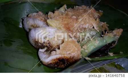 Low angle shot of traditional snacks in Indonesia. a popular snack with brown sugar sauce and grated coconut. Low angle shot of traditional snacks in Indonesia. a popular snack with brown sugar sauce and grated coconut. 141640758