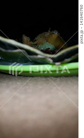 Low angle shot of traditional snacks in Indonesia. a popular snack with brown sugar sauce and grated coconut. Low angle shot of traditional snacks in Indonesia. a popular snack with brown sugar sauce and grated coconut. 141640760