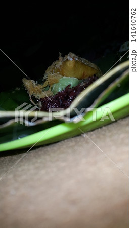 Low angle shot of traditional snacks in Indonesia. a popular snack with brown sugar sauce and grated coconut. Low angle shot of traditional snacks in Indonesia. a popular snack with brown sugar sauce and grated coconut. 141640762