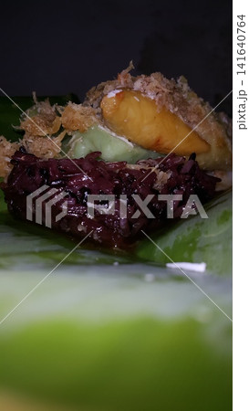 Low angle shot of traditional snacks in Indonesia. a popular snack with brown sugar sauce and grated coconut. Low angle shot of traditional snacks in Indonesia. a popular snack with brown sugar sauce and grated coconut. 141640764