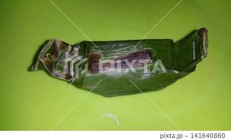 Shot of chicken lemper still wrapped in pisan leaves. Shot of chicken lemper still wrapped in pisan leaves. 141640860