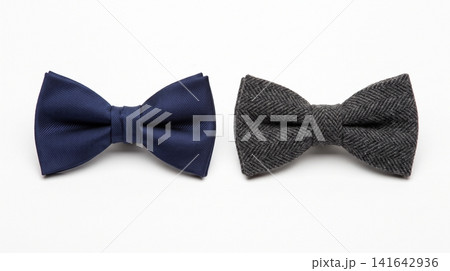 Pair of elegant bow ties in navy blue and charcoal grey fabric with accessory neckwear clothing charcoal sartorial gentleman masculine occasion isolated background sidebyside symmetrical Pair of elegant bow ties in navy blue and charcoal grey fabric with accessory neckwear clothing charcoal sartorial gentleman masculine occasion isolated background sidebyside symmetrical 141642936