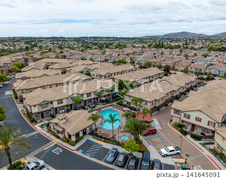An aerial view of a large housing community near Otay Lakes in Chula Vista featuring dense suburban single-family blocks, San Diego An aerial view of a large housing community near Otay Lakes in Chula Vista featuring dense suburban single-family blocks, San Diego 141645091
