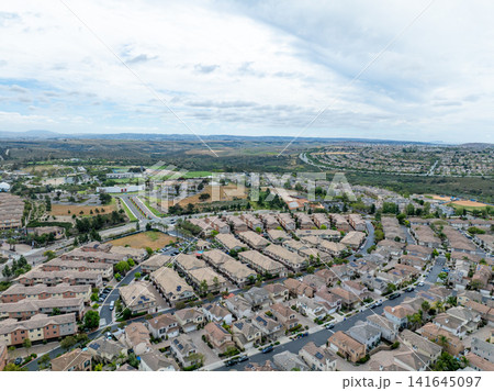 An aerial view of a large housing community near Otay Lakes in Chula Vista featuring dense suburban single-family blocks, San Diego An aerial view of a large housing community near Otay Lakes in Chula Vista featuring dense suburban single-family blocks, San Diego 141645097