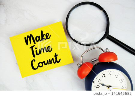 Make Time Count text with sticky note and alarm clock flat lay on marble background Make Time Count text with sticky note and alarm clock flat lay on marble background 141645683