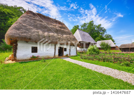 Remarkable summer scene of traditional romanian peasant houses. Remarkable summer scene of traditional romanian peasant houses. 141647687