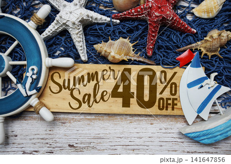 Summer Sale 40% off text on wooden sign decorated with marine nautical on a wooden background Summer Sale 40% off text on wooden sign decorated with marine nautical on a wooden background 141647856