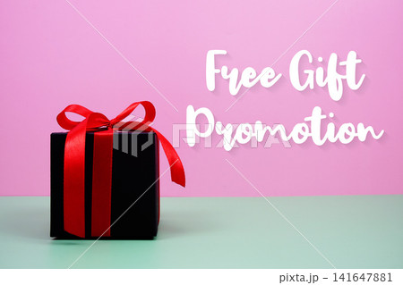Free Gift Promotion text with gift box on pink background Free Gift Promotion text with gift box on pink background 141647881