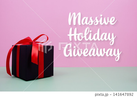 Massive Holiday Giveaway text with gift box on pink background Massive Holiday Giveaway text with gift box on pink background 141647892