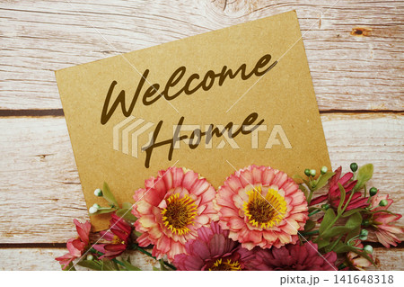 Welcome Home text written on paper card with flowers decorations 141648318