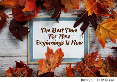 The Best Time For New Beginnings Is Now text with maple leaf decoration on wooden background The Best Time For New Beginnings Is Now text with maple leaf decoration on wooden background 141648338