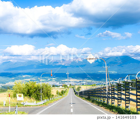 青空と雲が広がる北海道上富良野八景とされる千望峠からの風景 141649103