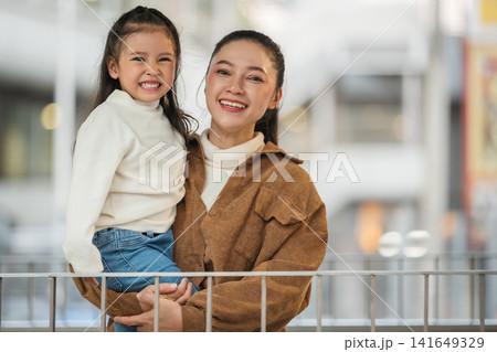 happy mother holding child girl sightseeing on footbridge in city happy mother holding child girl sightseeing on footbridge in city 141649329