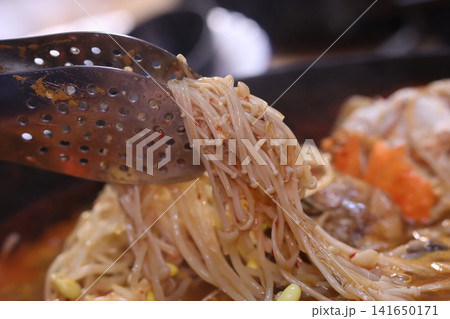 Enoki Mushrooms Lifted from Hot Pot Dish 141650171