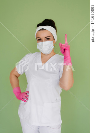 Doctor Pointing Finger up with Pink Glove Doctor Pointing Finger up with Pink Glove 141650895