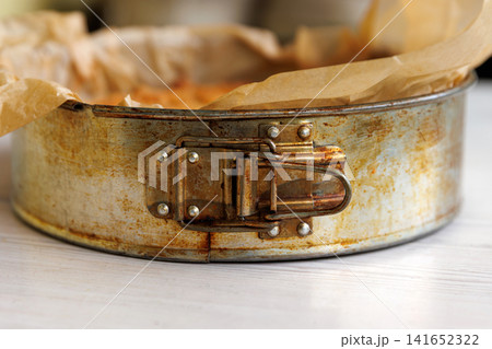 Whole homemade cherry crumb cake with golden streusel topping in a parchment-lined metal springform pan. Selective focus Whole homemade cherry crumb cake with golden streusel topping in a parchment-lined metal springform pan. Selective focus 141652322