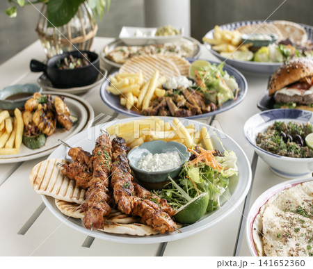 spicy marinated chicken skewer shish kebab mediterranean fusion meal on outdoor garden turkish restaurant table spicy marinated chicken skewer shish kebab mediterranean fusion meal on outdoor garden turkish restaurant table 141652360