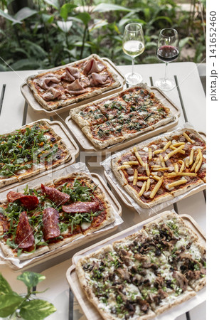 many different Pinsa types on garden restaurant pizza slice buffet table outdoors many different Pinsa types on garden restaurant pizza slice buffet table outdoors 141652460
