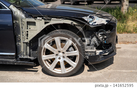 Damaged black car with missing front fender and exposed inner structure after accident Damaged black car with missing front fender and exposed inner structure after accident 141652595