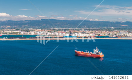 Aerial panorama of red cargo tanker near Tarragona industrial harbor and refinery on Mediterranean coast in Spain Aerial panorama of red cargo tanker near Tarragona industrial harbor and refinery on Mediterranean coast in Spain 141652631