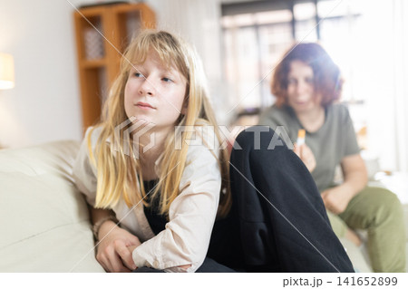 Teenage girl ignoring adult, experiencing conflict and family problems Teenage girl ignoring adult, experiencing conflict and family problems 141652899