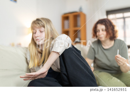Daughter rejecting mother's drug offer at home Daughter rejecting mother's drug offer at home 141652931