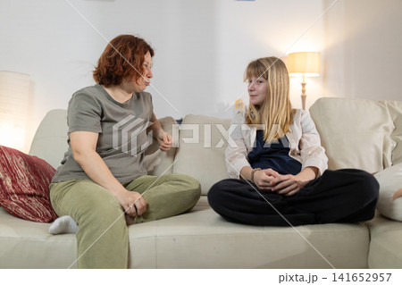 Mother and daughter having a serious conversation at home 141652957