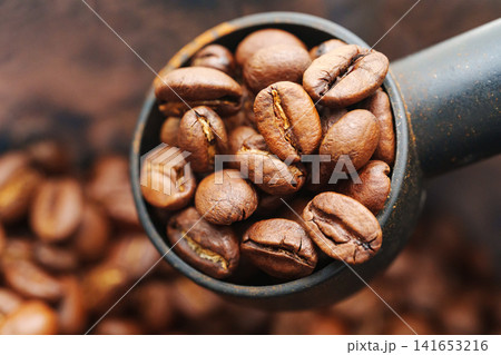 Bowl full of roasted coffee beans ready for brewing in the morning Bowl full of roasted coffee beans ready for brewing in the morning 141653216
