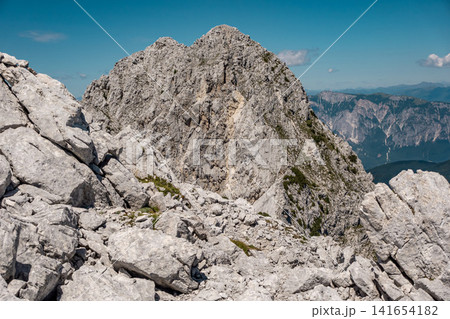 View from the middle Ponza mountain in Triglav National Park, Slovenia, towards the high Ponza peak with white rocky alpine valley routes, steep Julian Alps ridges and dramatic high mountain landscape View from the middle Ponza mountain in Triglav National Park, Slovenia, towards the high Ponza peak with white rocky alpine valley routes, steep Julian Alps ridges and dramatic high mountain landscape 141654182