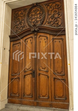 Ornate Wooden Portal Door with Carved Transom Panel at Historic Building Entrance in Vienna Austria Ornate Wooden Portal Door with Carved Transom Panel at Historic Building Entrance in Vienna Austria 141654864