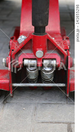 A red car hydraulic lift. A red car hydraulic lift. 141655298
