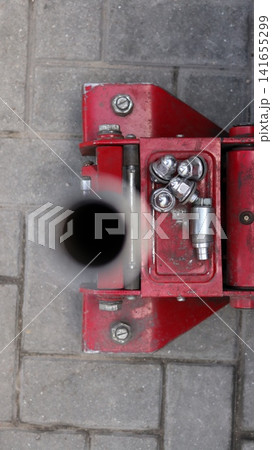 A red car hydraulic lift. A red car hydraulic lift. 141655299