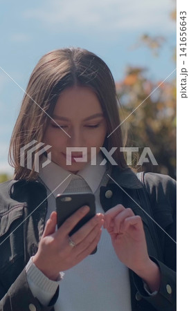 Vertical video. Professional woman walking in the city, sunny day. Vertical video. Professional woman walking in the city, sunny day. 141656643