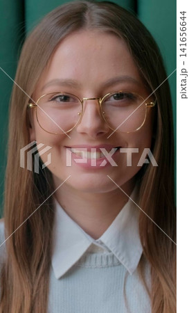 Vertical video. Portrait shot of professional woman smiling while working in the urban office. Close up. 141656644