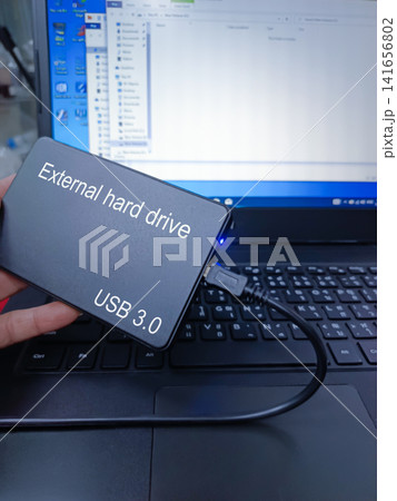 Connecting an external hard drive to a computer. Connecting an external hard drive to a computer. 141656802