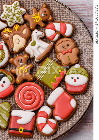 Gingerbread as a Christmas staple, sweet biscuits for the holiday. Gingerbread as a background Gingerbread as a Christmas staple, sweet biscuits for the holiday. Gingerbread as a background 141657371