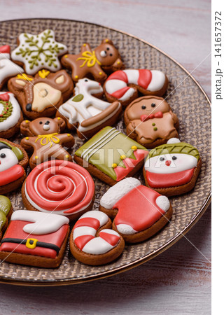 Gingerbread as a Christmas staple, sweet biscuits for the holiday. Gingerbread as a background Gingerbread as a Christmas staple, sweet biscuits for the holiday. Gingerbread as a background 141657372