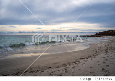 Stokes Bay Beach at sunset with waves and rocks, Australia Stokes Bay Beach at sunset with waves and rocks, Australia 141657655