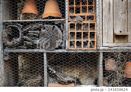 Wood, straw, and terracotta in a wooden animal shelter Wood, straw, and terracotta in a wooden animal shelter 141658624
